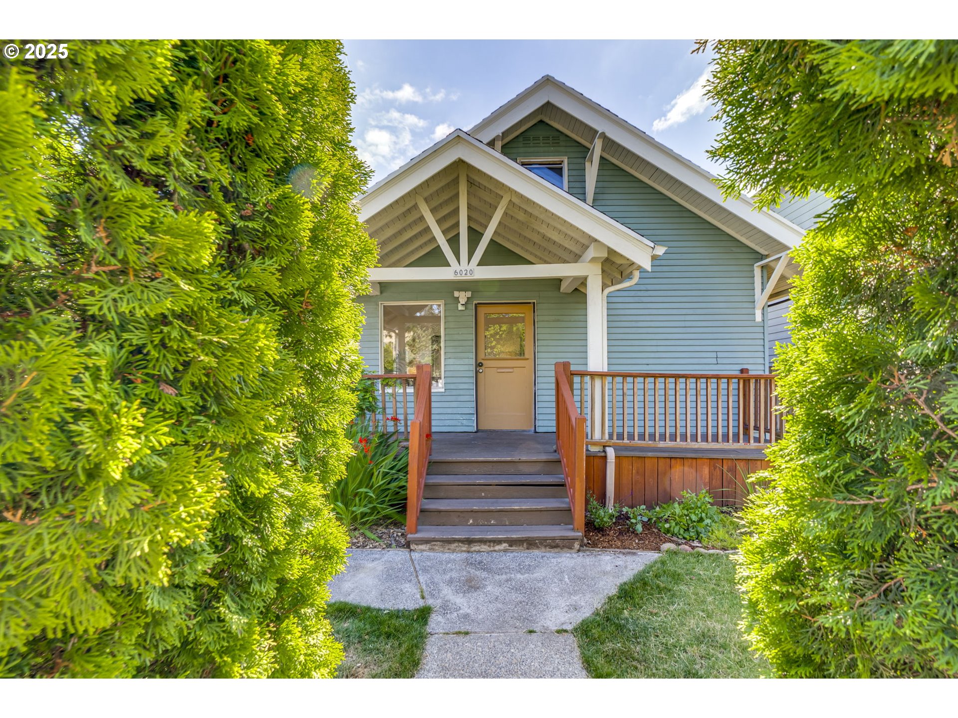 6020 Southeast 83rd Avenue Portland, OR 97266 - Photo 3 of 46 a front view of a house with a yard