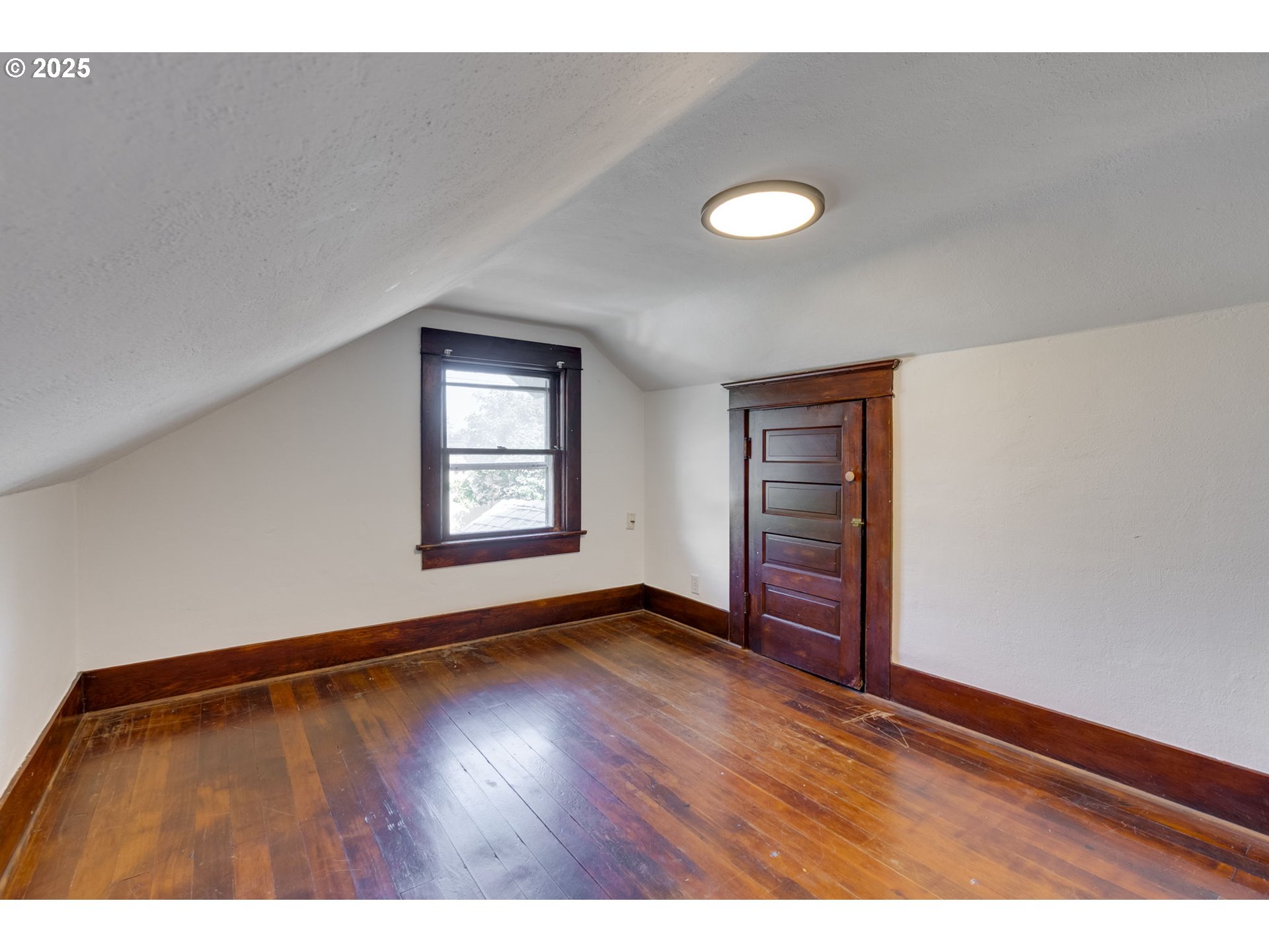 6020 Southeast 83rd Avenue Portland, OR 97266 - Photo 34 of 46 a view of an empty room with wooden floor and a window