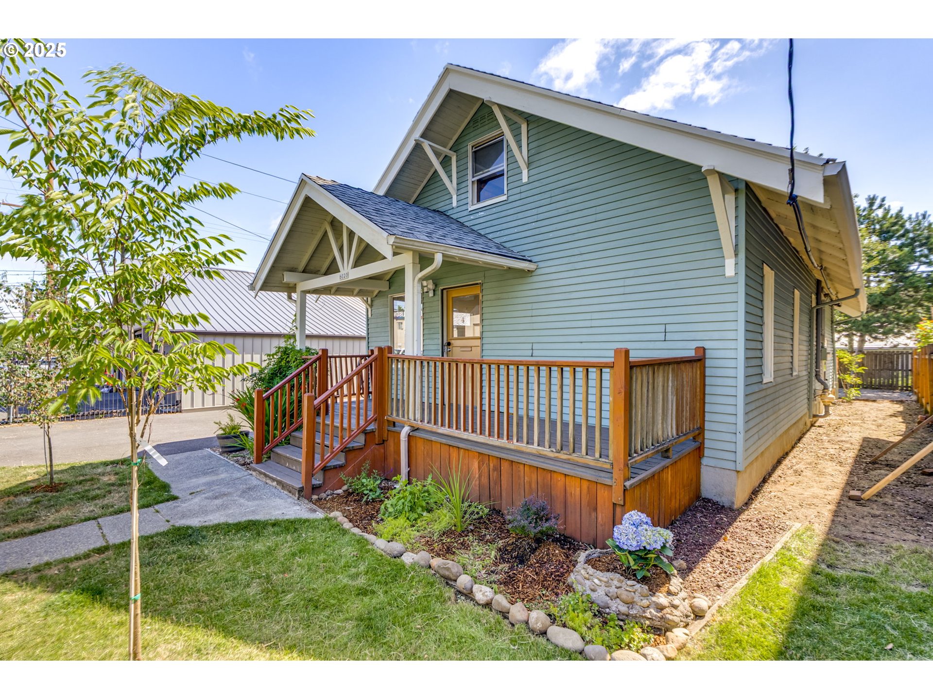 6020 Southeast 83rd Avenue Portland, OR 97266 - Photo 45 of 46 a view of a house with a small yard and wooden fence