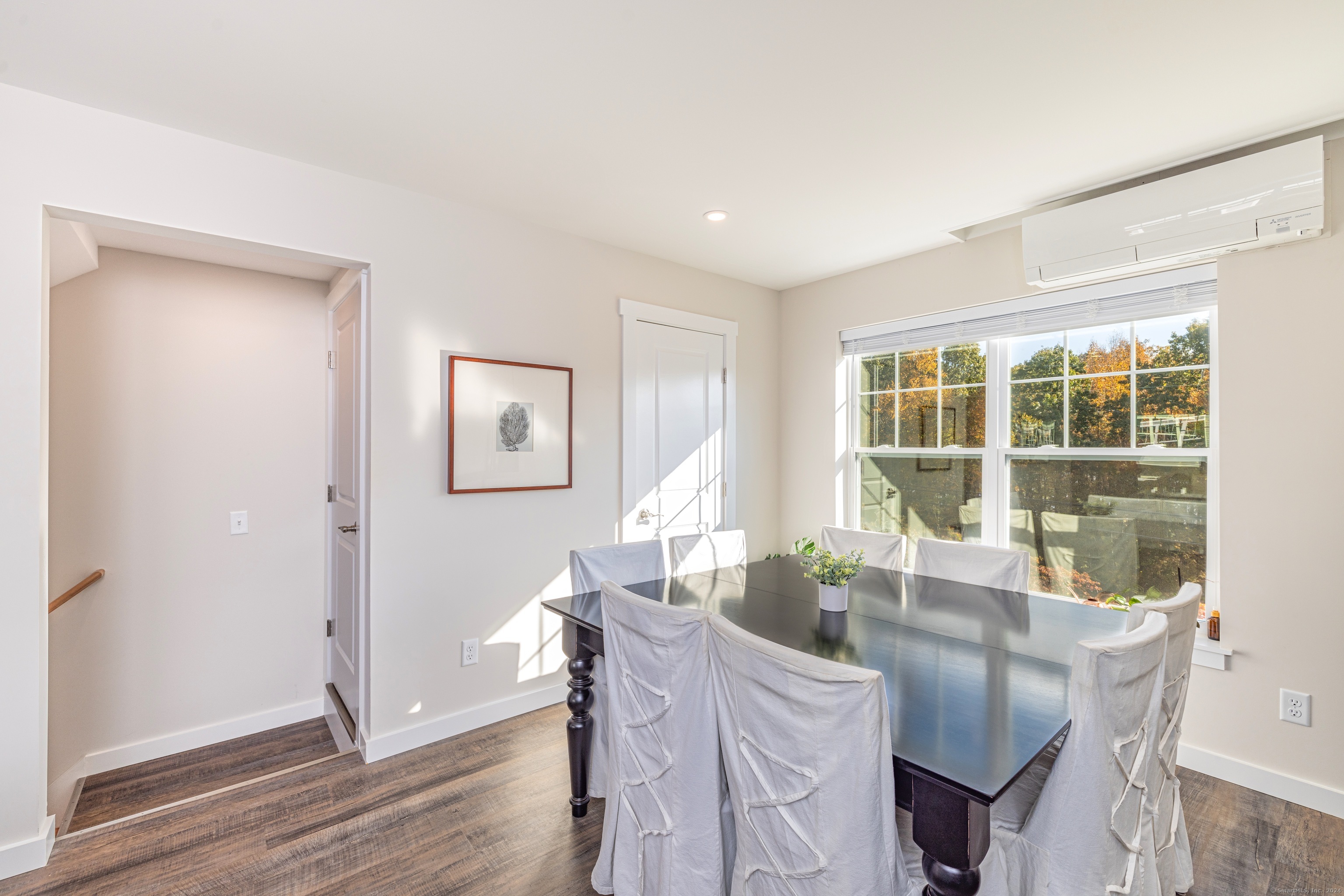 94 North Bridebrook Road, Unit 310 East Lyme, CT 06357 - Photo 8 of 19 a view of a dining room with furniture large window and wooden floor