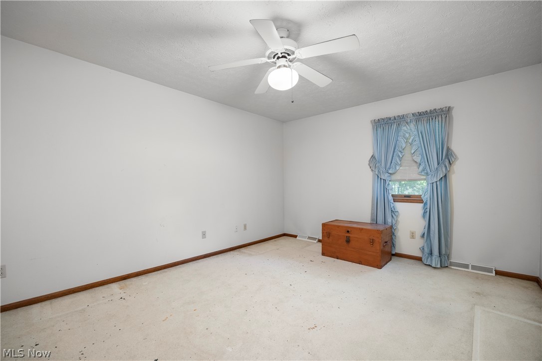 722 Jaycox Road Avon Lake, OH 44012 - Photo 33 of 48 Room featuring a window, white walls, wood-finish baseboards, and a ceiling fan with integrated lighting