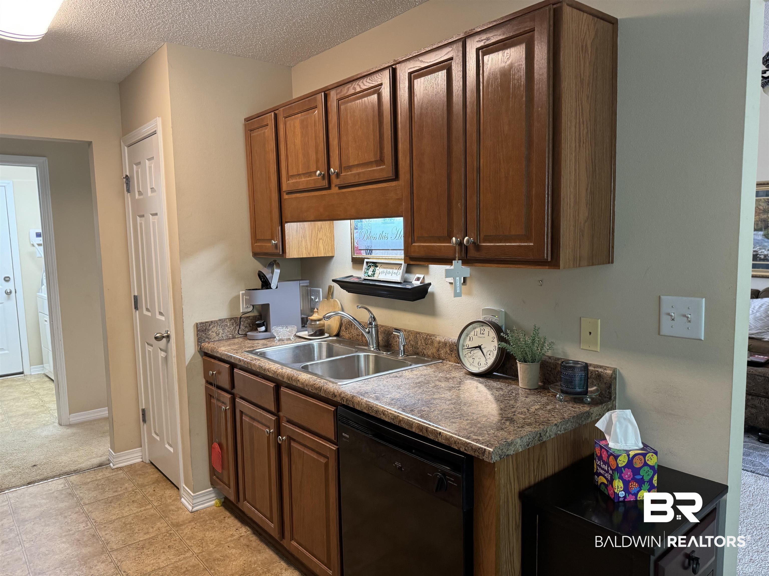 2245 Spring Grove North Mobile, AL 36695 - Photo 4 of 10 Kitchen featuring dishwasher, a textured ceiling, and dark countertops