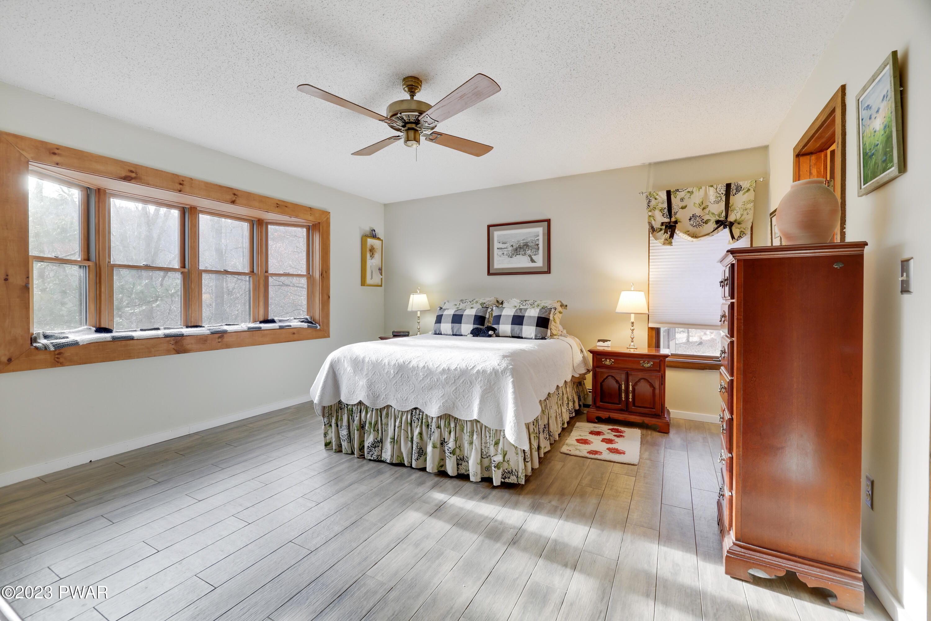 6348 Decker Road Bushkill, PA 18324 - Photo 10 of 36 a bedroom with a large bed and a chandelier