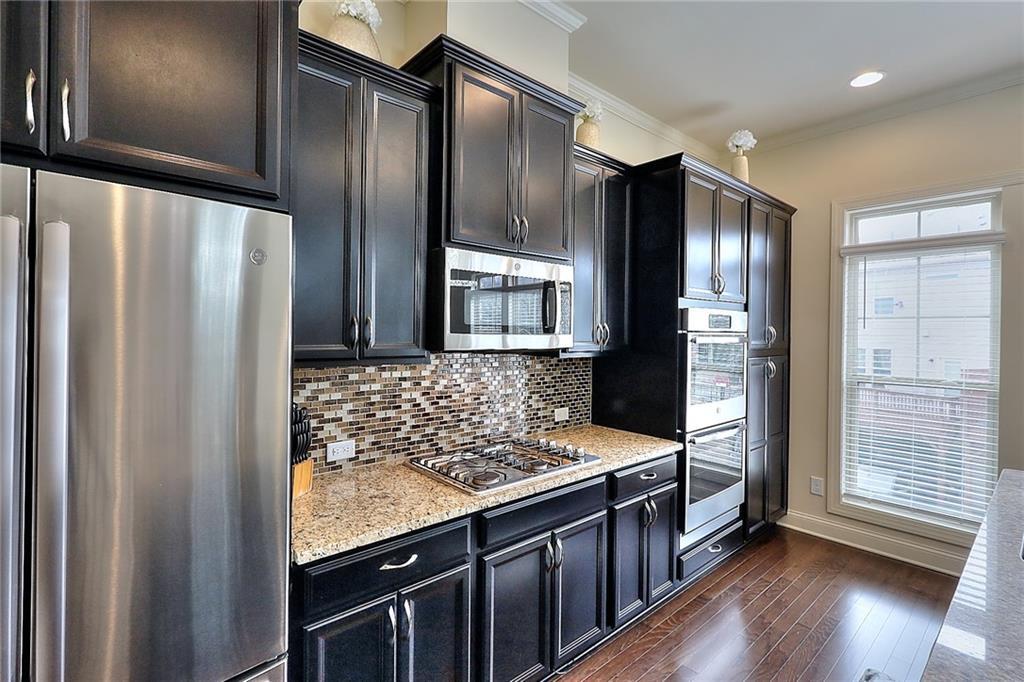 1306 Harris Way South Atlanta, GA 30319 - Photo 3 of 19 a kitchen with stainless steel appliances granite countertop a refrigerator and a stove