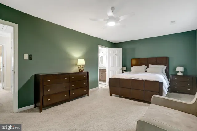 a spacious bedroom with a bed and a ceiling fan