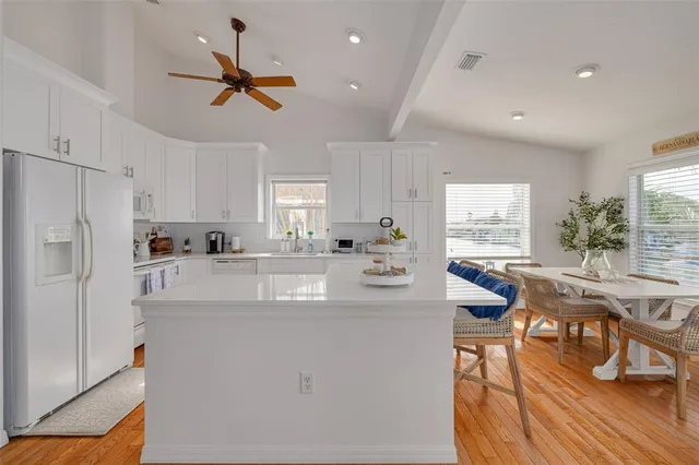 a kitchen with stainless steel appliances granite countertop a white cabinets and couches