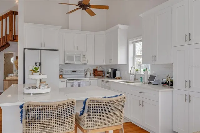 a kitchen with a sink cabinets and window