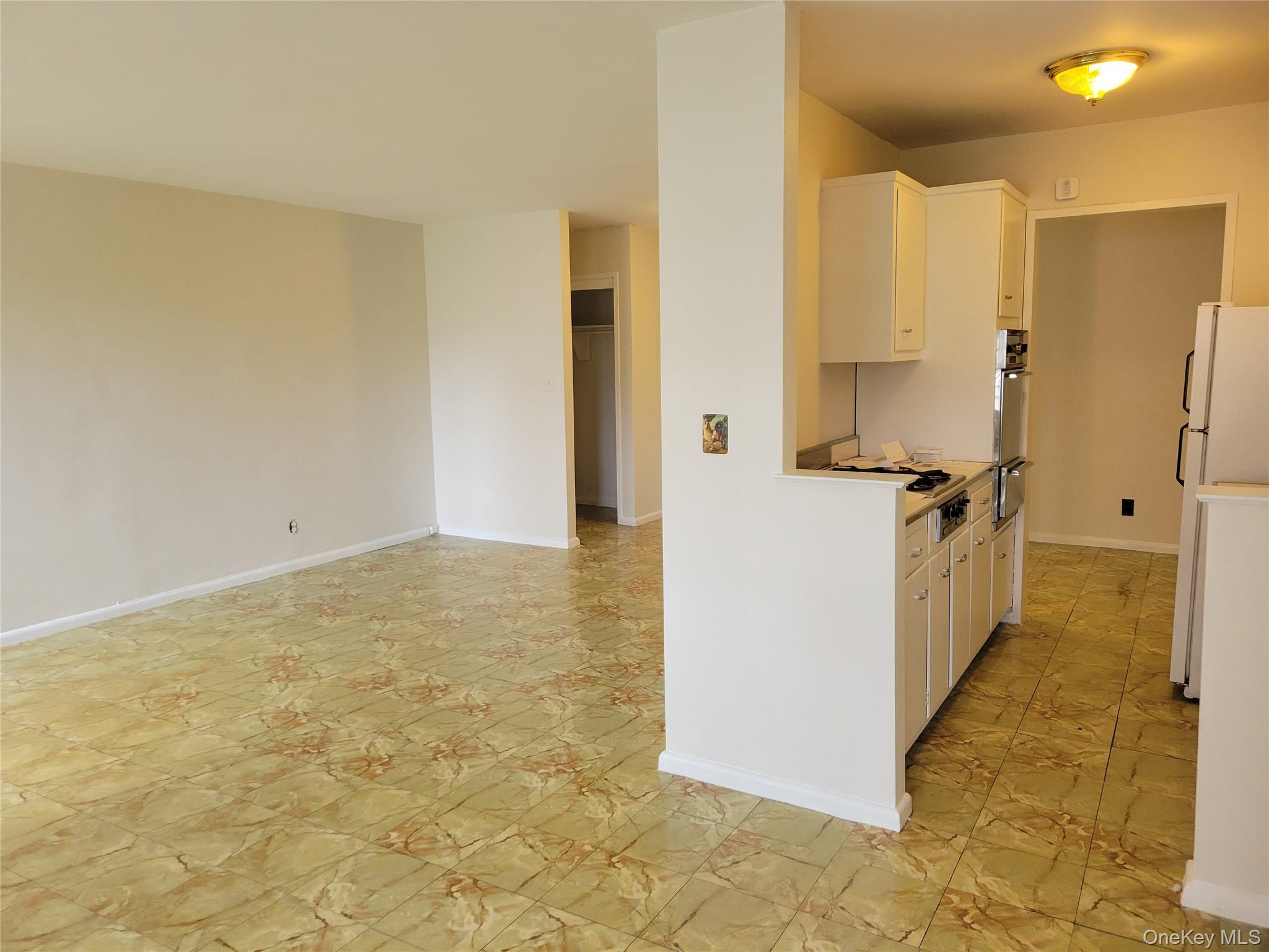 138-10 Franklin Avenue, Unit 5H Queens, NY 11355 - Photo 3 of 8 a view of a kitchen cabinets and wooden floor