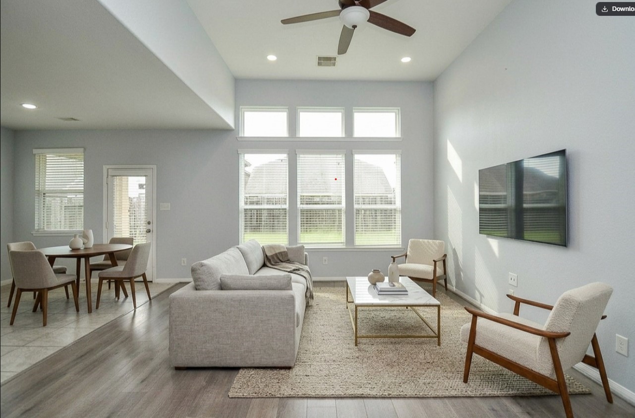7042 Sliding Rock Circle Spring, TX 77379 - Photo 7 of 36 Experience the inviting ambiance of this virtually staged living room, featuring abundant natural light, modern furnishings, and an open layout perfect for relaxation and entertainment.