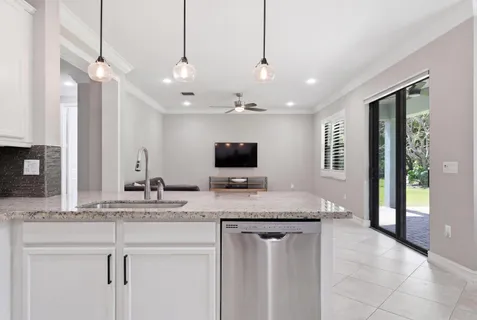 a living room with furniture and kitchen view