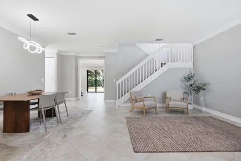a view of a livingroom with furniture and stairs