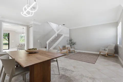 a living room with chairs and a table