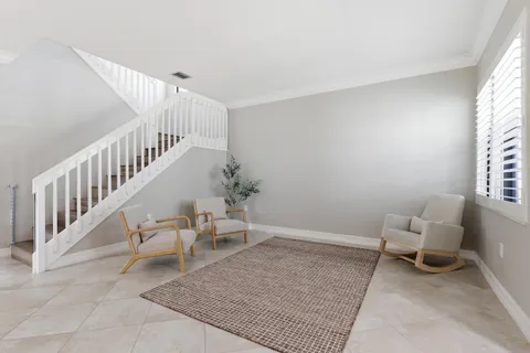 a kitchen with stainless steel appliances granite countertop a stove top oven a sink a dining table and chairs with wooden floor