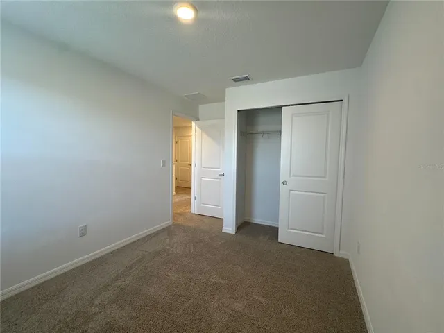 an empty room with closet area