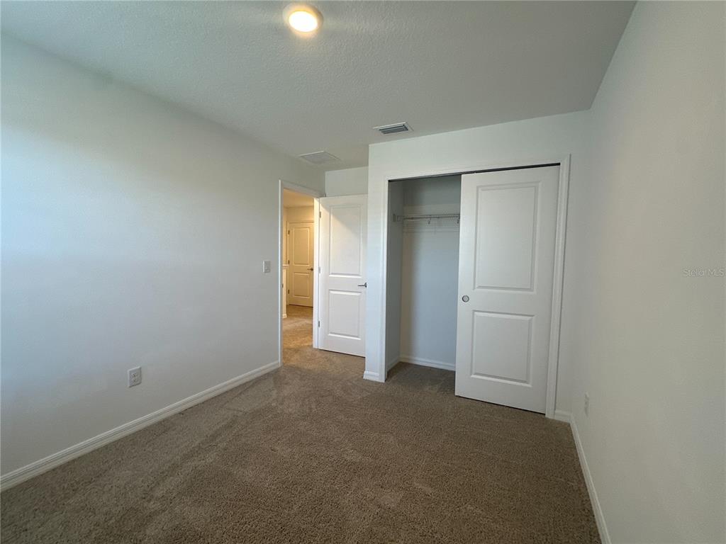 2416 Paravane Way Wesley Chapel, FL 33543 - Photo 18 of 35 an empty room with closet area