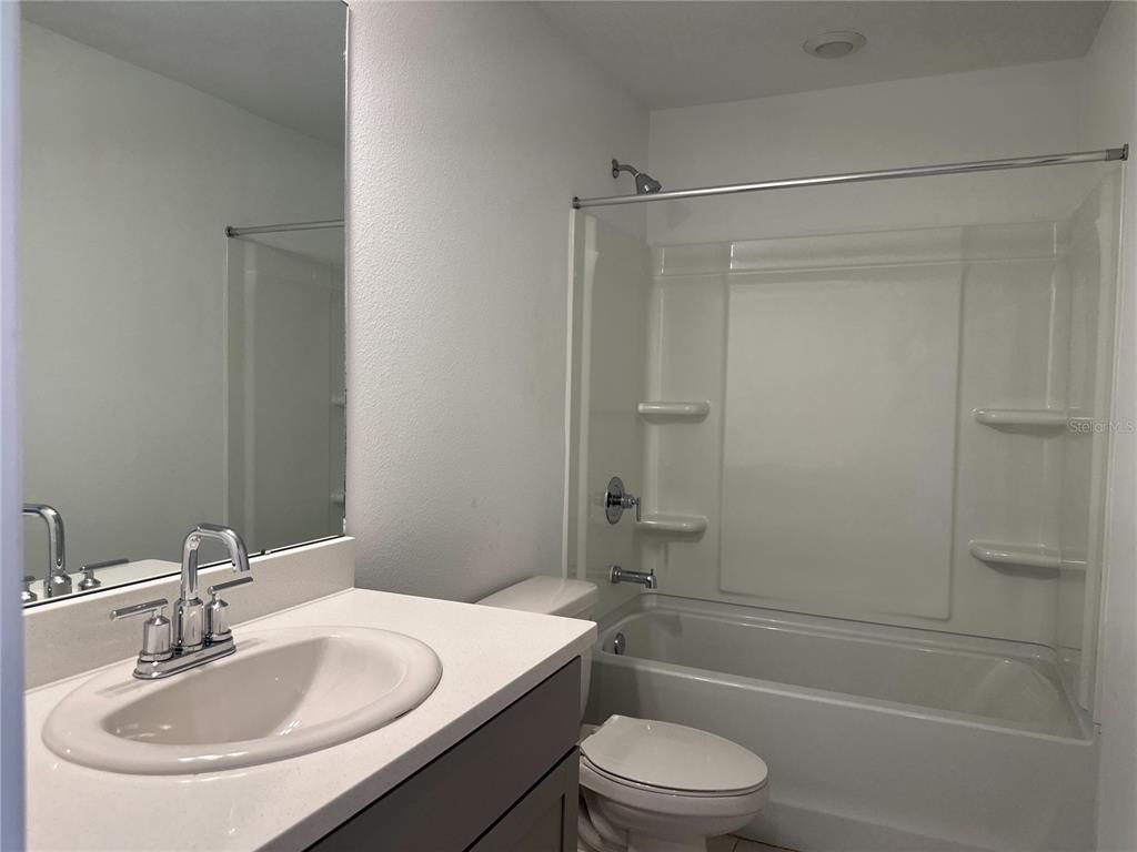 2416 Paravane Way Wesley Chapel, FL 33543 - Photo 20 of 35 a bathroom with a sink toilet and shower