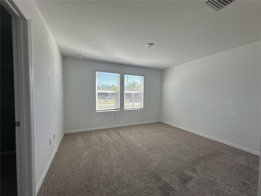 2416 Paravane Way Wesley Chapel, FL 33543 - Photo 26 of 35 an empty room with windows