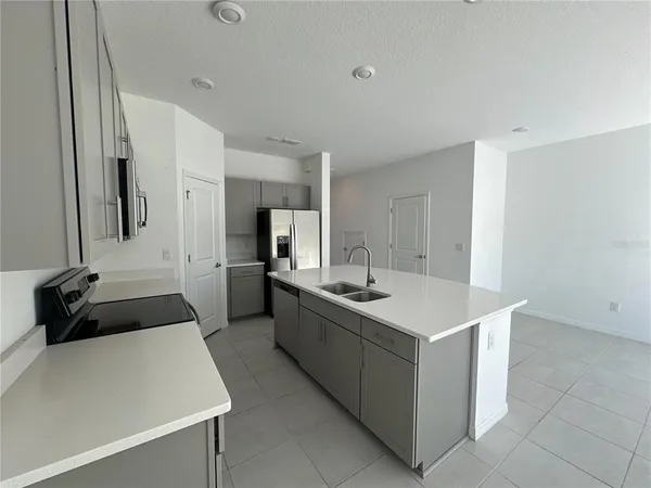 a kitchen with a sink and a stove top oven