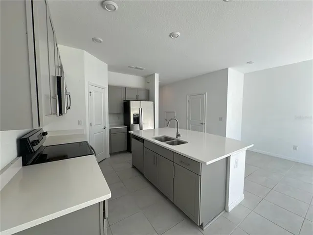 a kitchen with a sink and a stove top oven