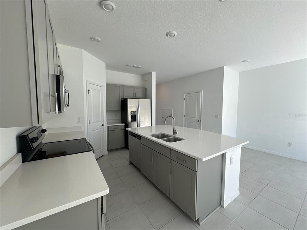 2416 Paravane Way Wesley Chapel, FL 33543 - Photo 5 of 35 a kitchen with a sink and a stove top oven
