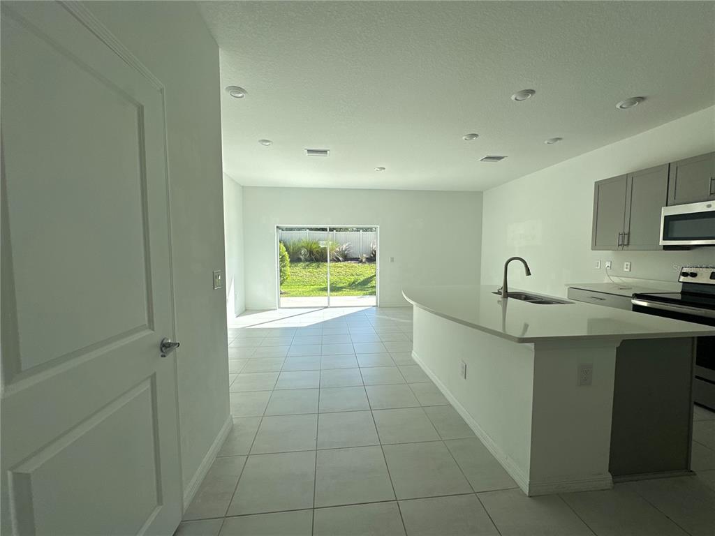 2416 Paravane Way Wesley Chapel, FL 33543 - Photo 9 of 35 a view of a kitchen with a sink a refrigerator and window