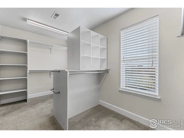 a bathroom with a sink double vanity granite tub and a mirror