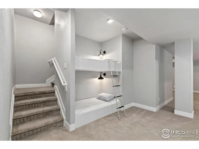 a kitchen with stainless steel appliances kitchen island granite countertop a table chairs in it and wooden floors