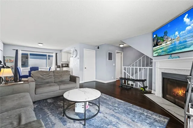 a living room with furniture a fireplace and a flat screen tv