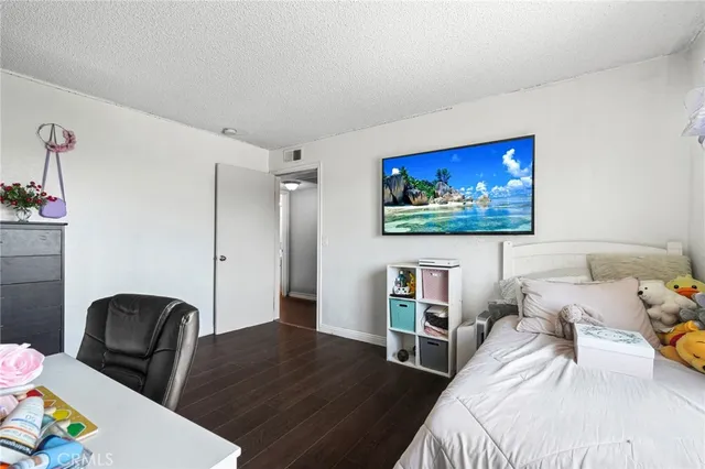 a bedroom with furniture and a flat screen tv