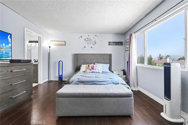 a bedroom with a large bed and a chandelier