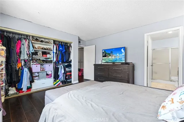 a bed room with a bed and a mirror