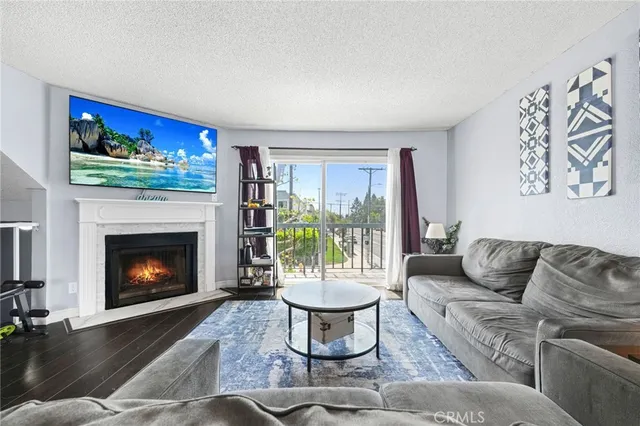 a living room with furniture a window and a fireplace