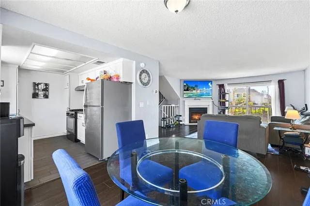 a living room with furniture a dining table and kitchen view