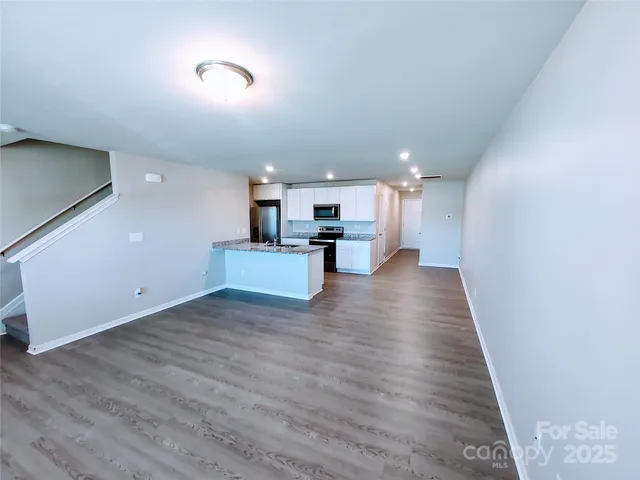 a view of kitchen and hall with wooden floor