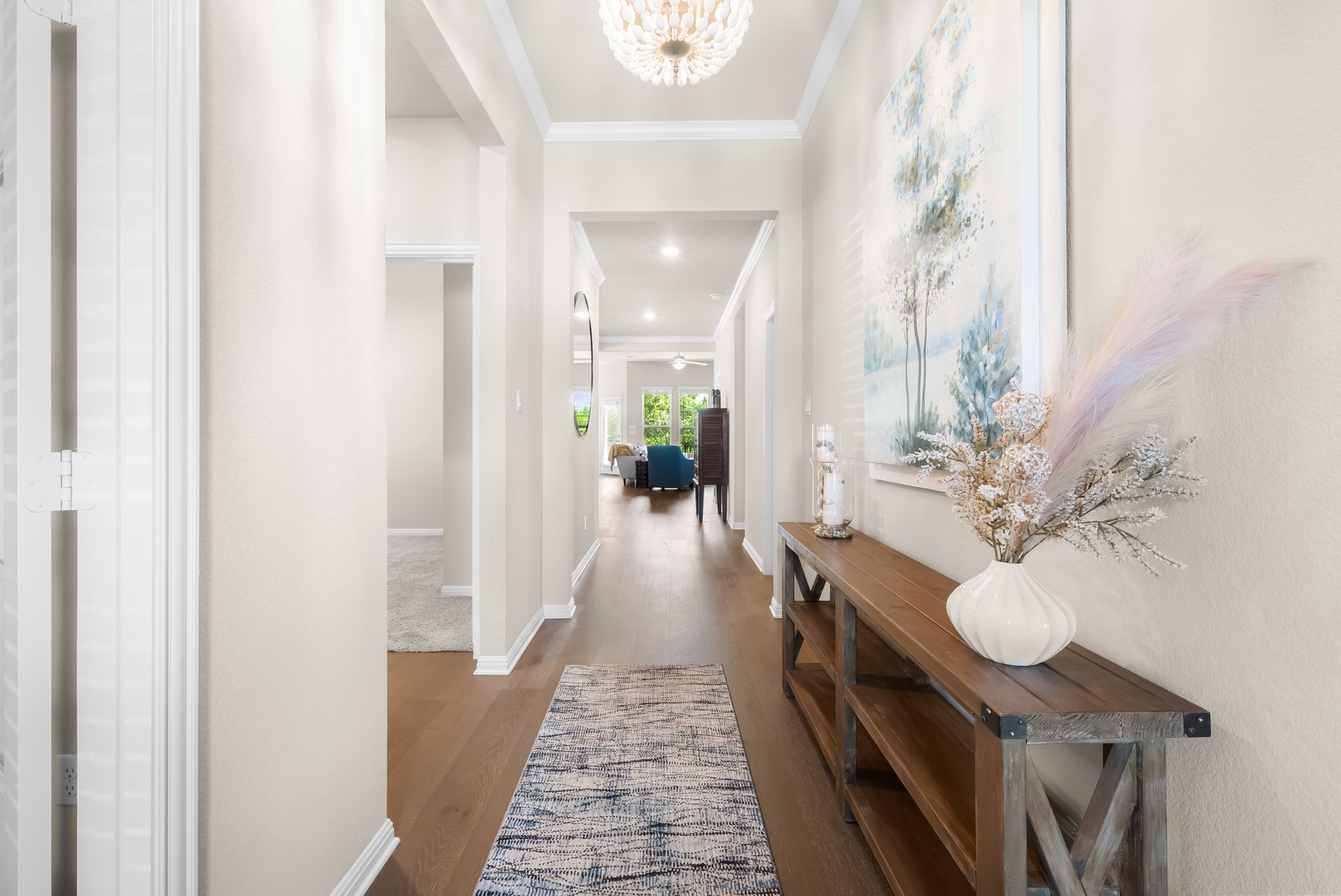 300 Prato Place Georgetown, TX 78628 - Photo 6 of 40 A graceful entry hall welcomes, showcasing rich hardwood floors and an elegant ceiling fixture.