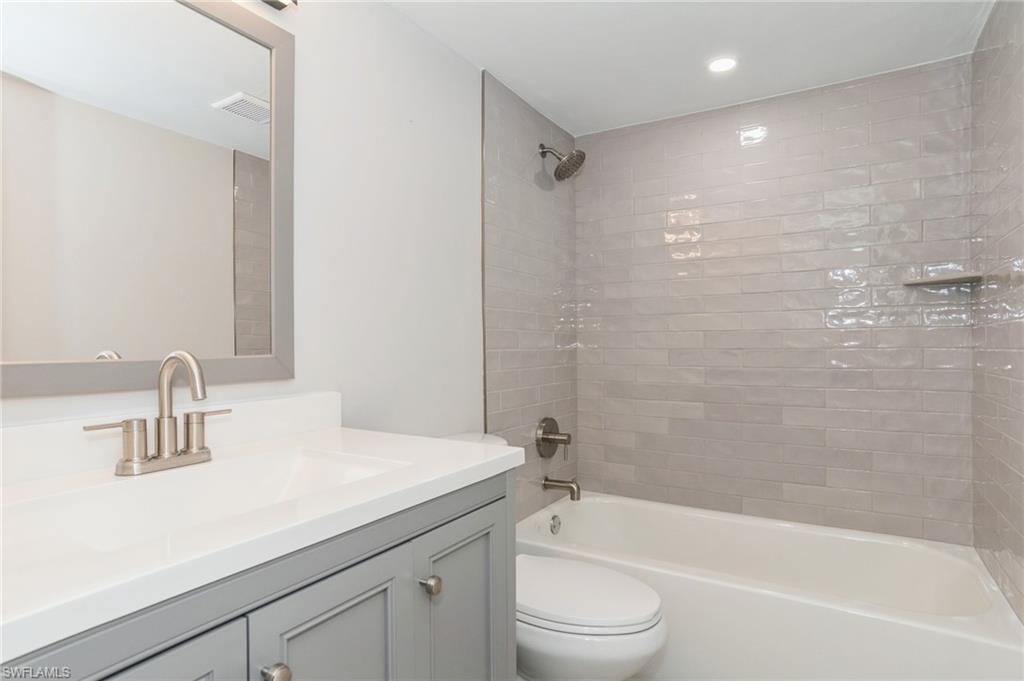 1155 Sandpiper Street, Unit B3 Naples, FL 34102 - Photo 12 of 21 Full bathroom featuring vanity, shower combination, and recessed lighting