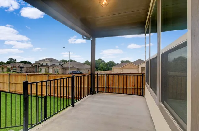 a view of a balcony with a floor to ceiling window and wooden floor