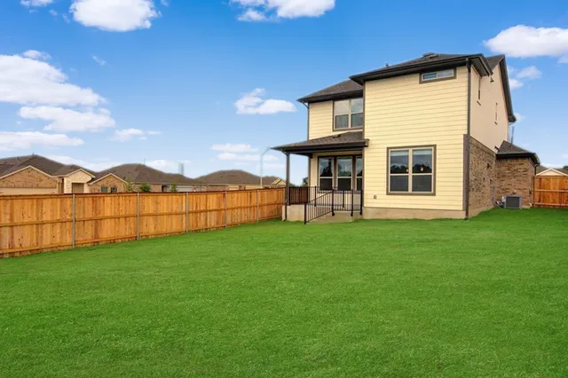 a view of a house with backyard and deck
