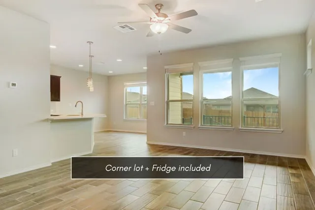 a view of an empty room with window and cabinet