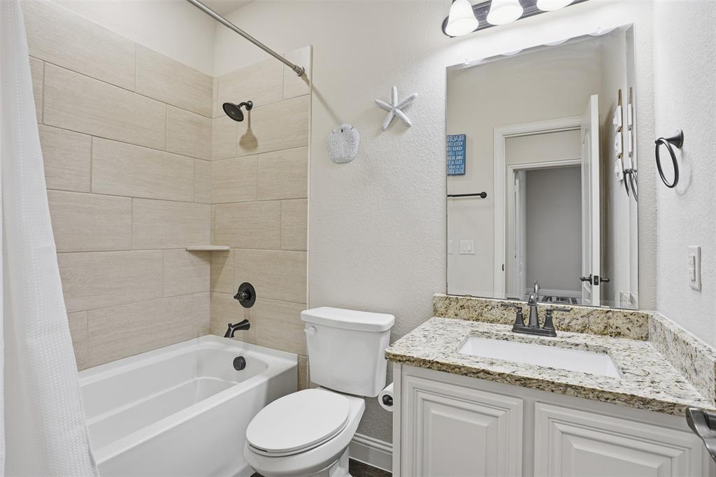 4002 Grove Valley Road Midlothian, TX 76065 - Photo 25 of 40 a bathroom with a granite countertop sink toilet and shower