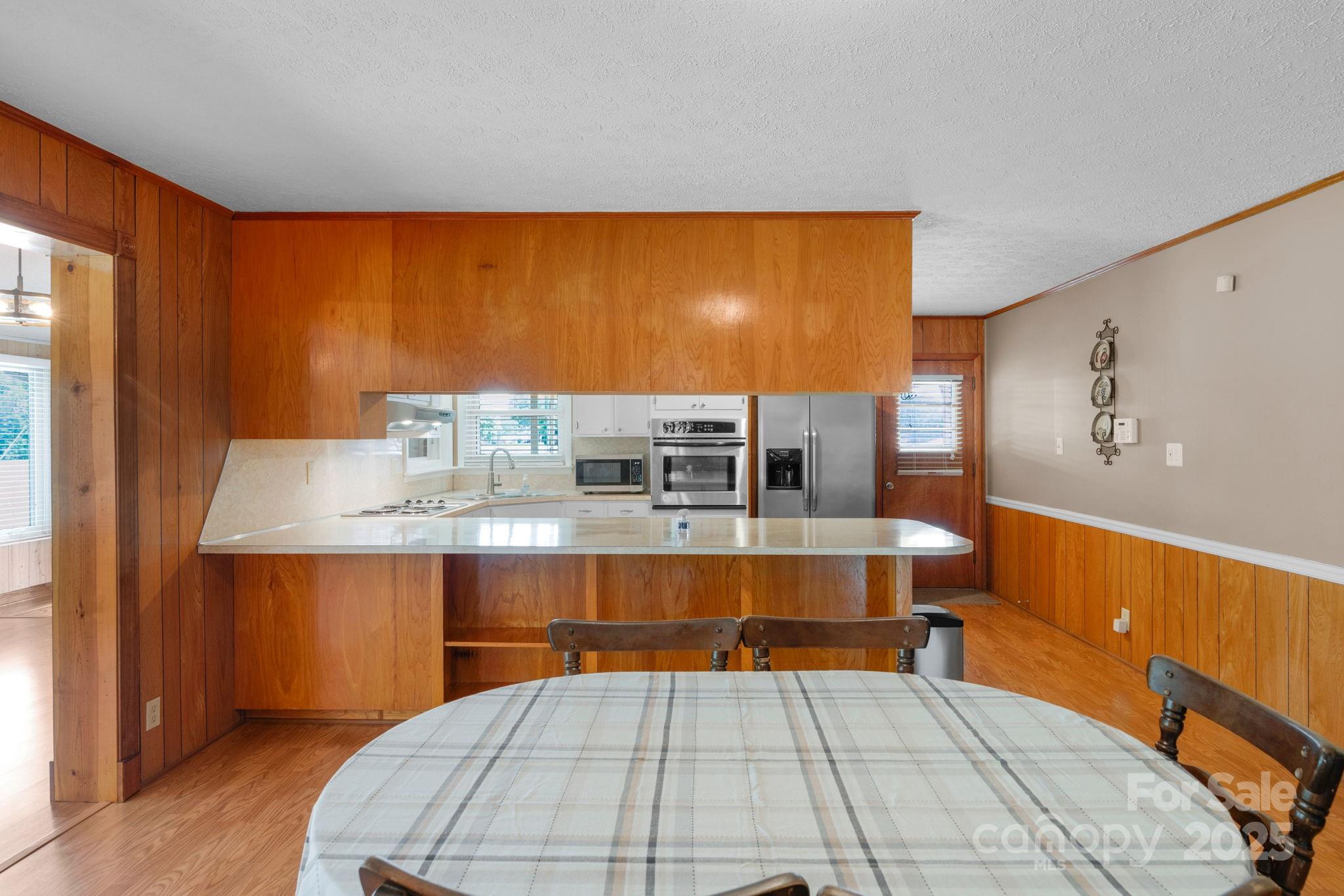 2036 Biggers Lake Road Shelby, NC 28152 - Photo 11 of 45 a room with a table chair and wooden floor