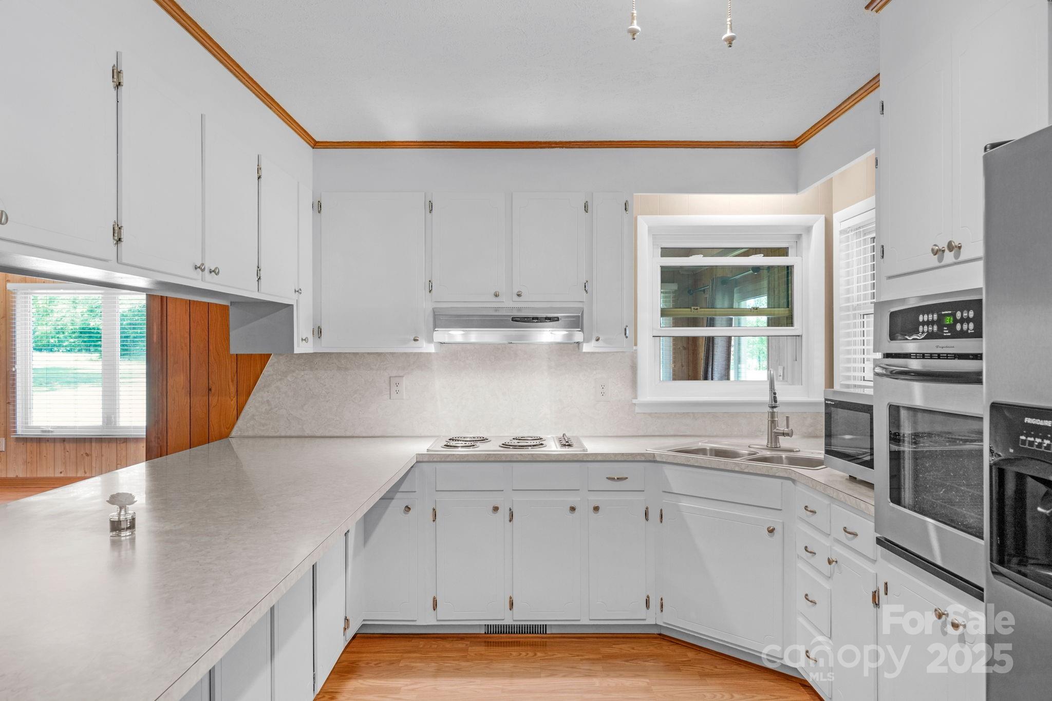 2036 Biggers Lake Road Shelby, NC 28152 - Photo 12 of 45 a kitchen with granite countertop a sink stainless steel appliances and cabinets