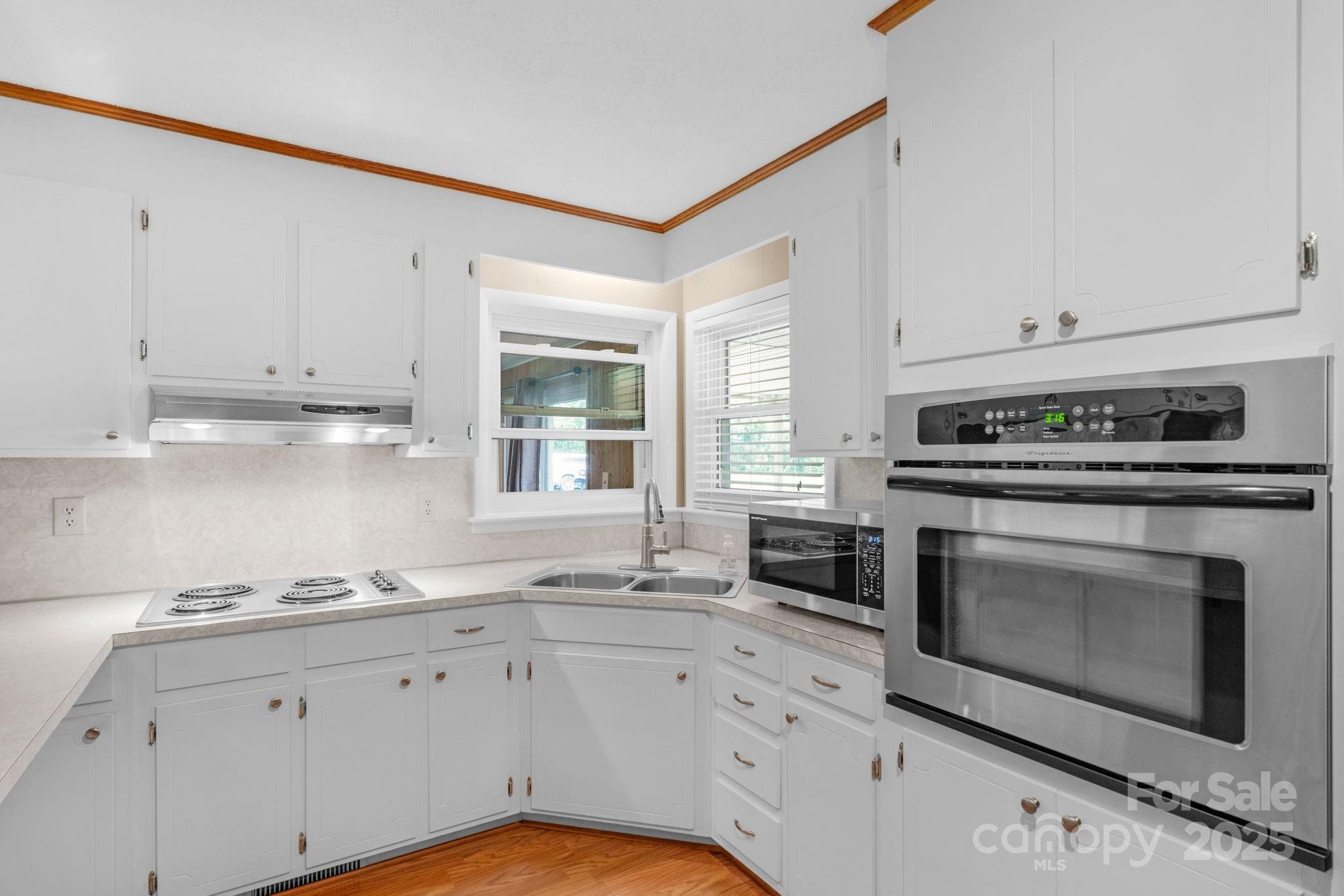 2036 Biggers Lake Road Shelby, NC 28152 - Photo 13 of 45 a kitchen with granite countertop a stove a sink and a white cabinets