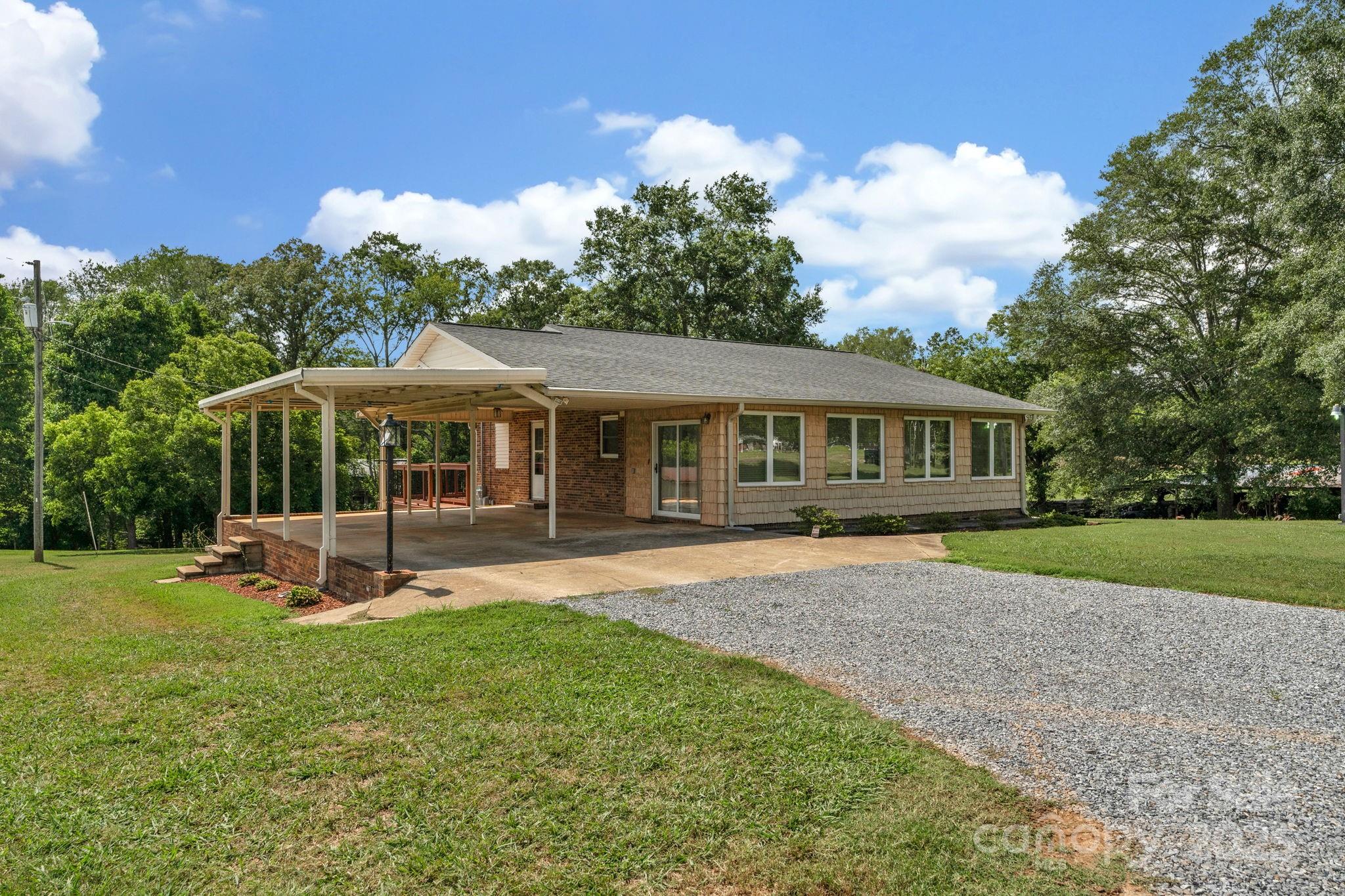 2036 Biggers Lake Road Shelby, NC 28152 - Photo 3 of 45 a front view of a house with a yard table and chairs