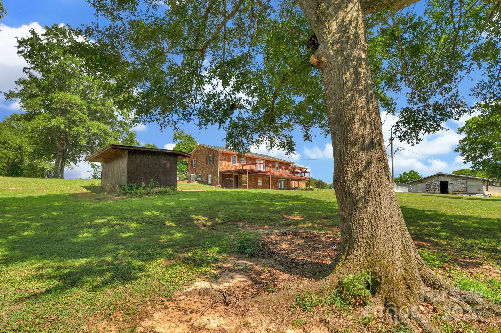 2036 Biggers Lake Road Shelby, NC 28152 - Photo 37 of 45 a view of a backyard with large trees