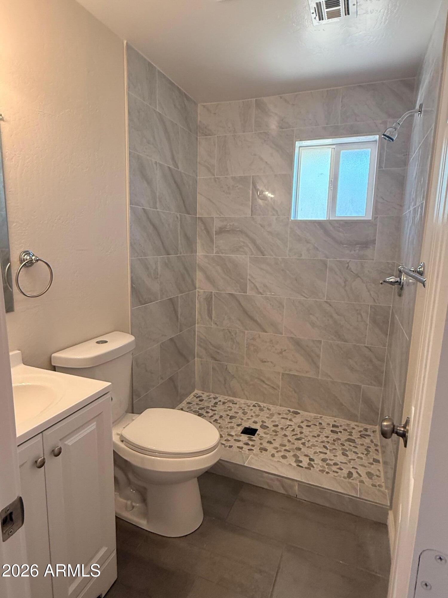 135 Rex Avenue Apache Junction, AZ 85120 - Photo 12 of 27 a bathroom with a toilet and a shower