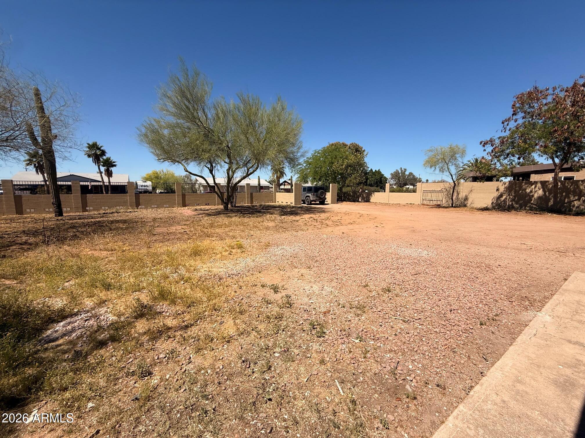 135 Rex Avenue Apache Junction, AZ 85120 - Photo 14 of 27 a view of a yard with a house