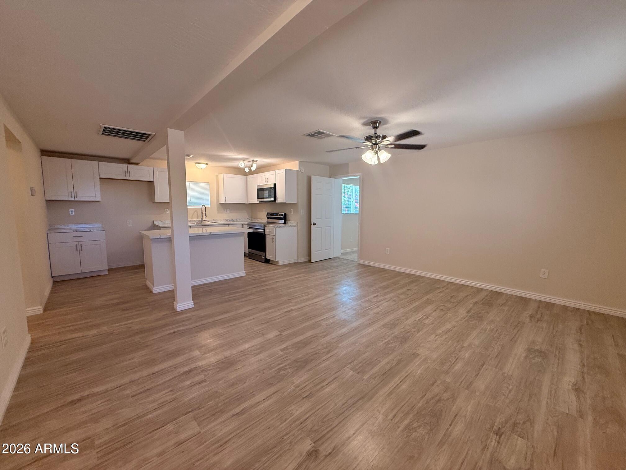 135 Rex Avenue Apache Junction, AZ 85120 - Photo 17 of 27 a view of an empty room with a window