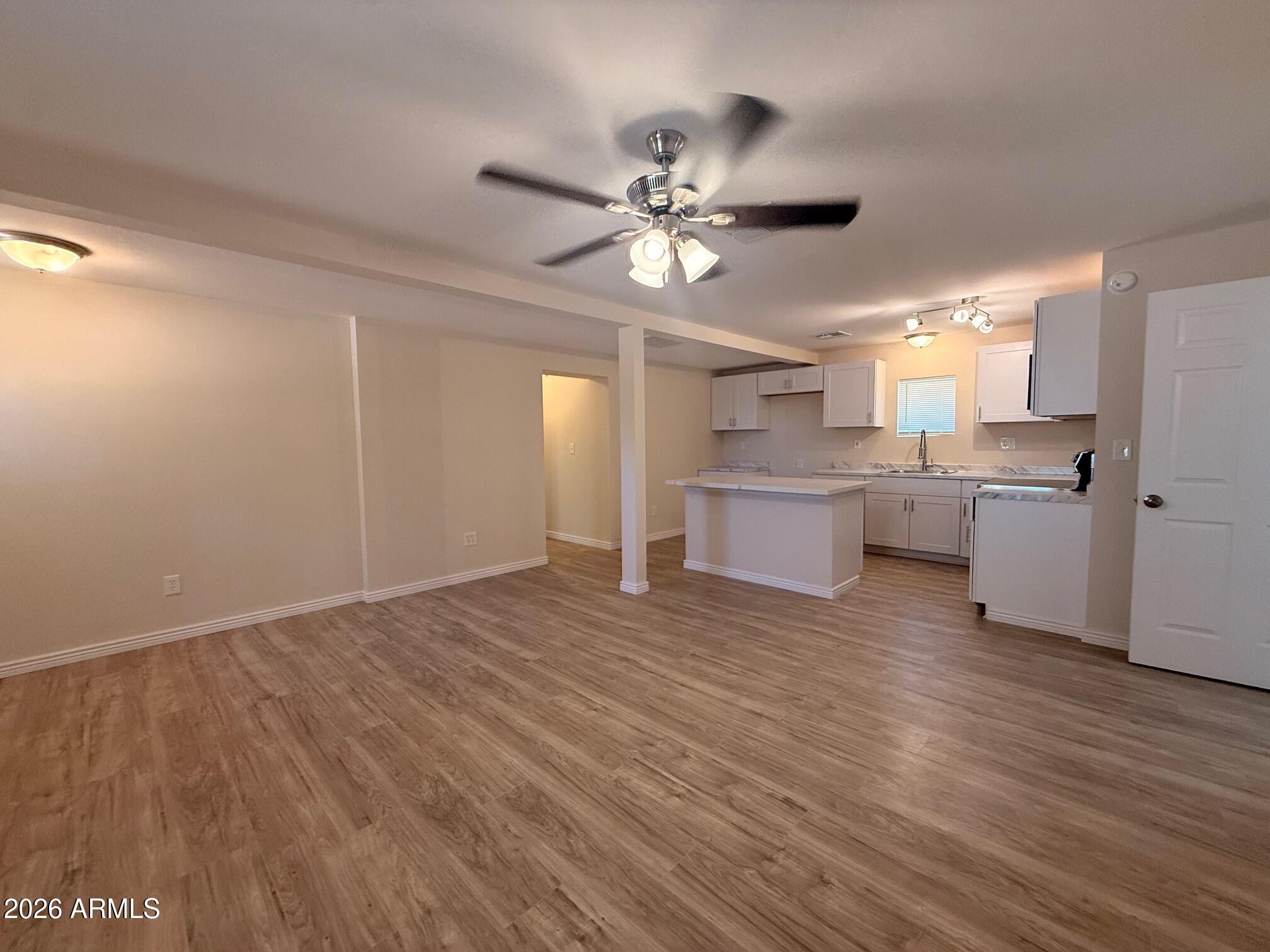 135 Rex Avenue Apache Junction, AZ 85120 - Photo 18 of 27 a view of a kitchen with a sink and a refrigerator