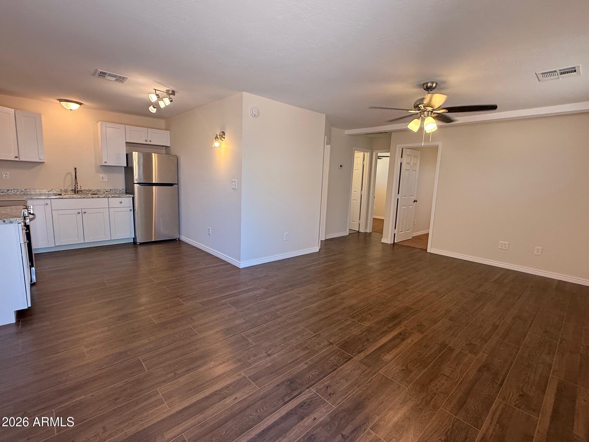 135 Rex Avenue Apache Junction, AZ 85120 - Photo 6 of 27 a view of an empty room with kitchen and a window